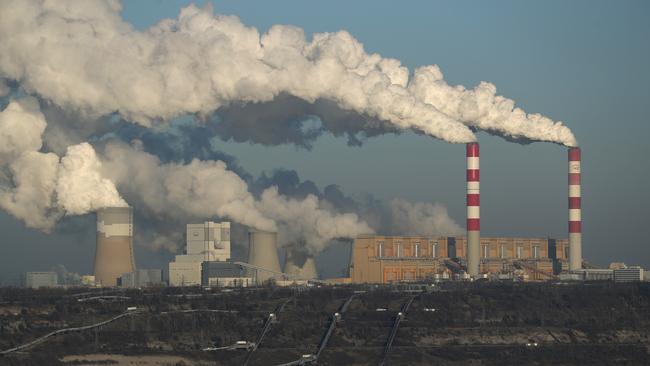 Steam and smoke rise from the Belchatow Power Station as the open-pit coal mine that feeds the station coal lies below in Rogowiec, Poland. Picture: Getty Images