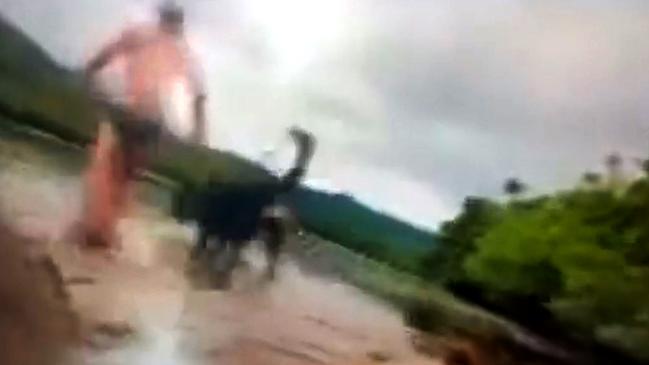 A video still of Alister MacPhee and his dog being attacked by a crocodile near the Bloomfield boat ramp in Far North Queensland in February.