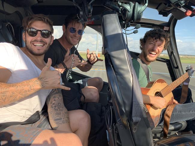 Luke Zocchi, Chris Hemsworth and Scott Hildebrand on the Avmin Air Charter private helicopter. Picture: Avmin Air Charter