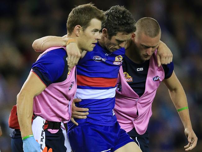 A dejected Murphy is carried helped off the ground after hurting his knee last year. Picture: Wayne Ludbey