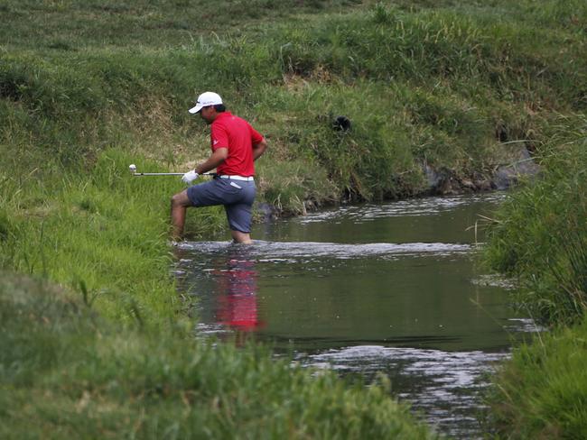 Jason Day crosses water on the second hole.