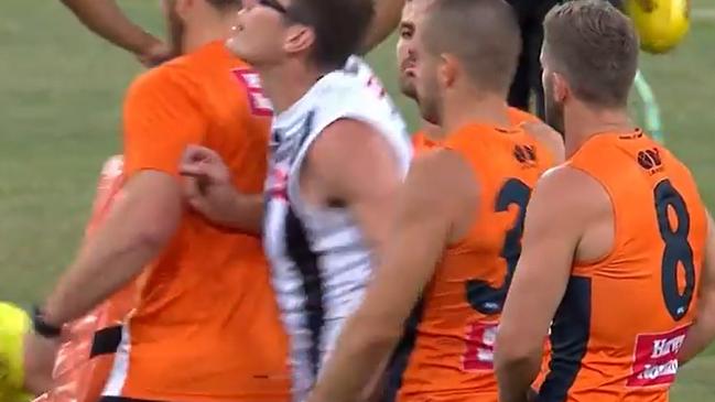 Pies ruckman Mason Cox - public enemy No.1 at GWS - runs through the Giants ruck warm-up and takes the ball