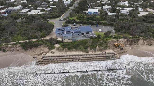 The Inverloch Surf Life Saving Club and surrounding homes are at risk of being “swept away” as coastal erosion grows rapidly worse after a recent storm surge. Picture: Supplied