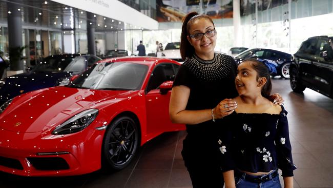 Porsche aficionado Niti Bajaj, with daughter Sana, eyes off another purchase at the Willoughby dealership in Sydney’s north. Picture: Nikki Short