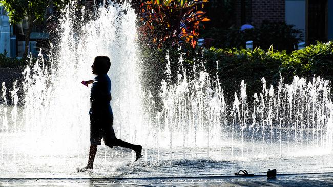 A child plays in the fountain at the Orion Springfield Central shopping centre. Picture: Richard Walker