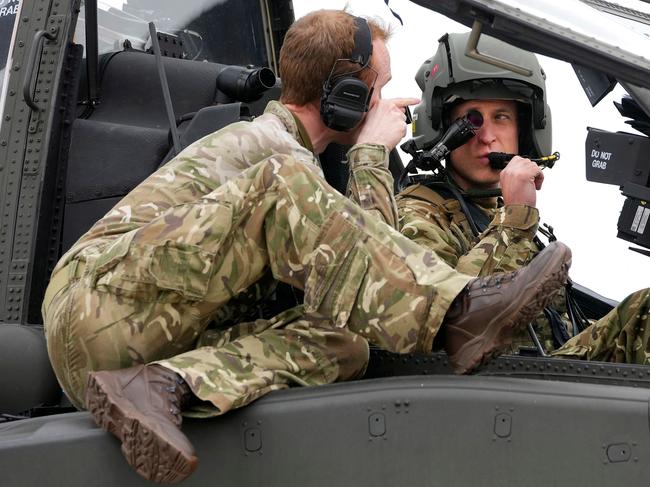 Britain's Prince William, Prince of Wales (R) receives advice as he sits in the cockpit of an Apache helicopter at the Army Aviation Centre in Middle Wallop, England, on Monday, May 13, 2024. Britain's King Charles III officially handed over the role of Colonel-in-Chief of the Army Air Corps to his son Britain's Prince William, Prince of Wales. (Photo by Kin Cheung / POOL / AFP)