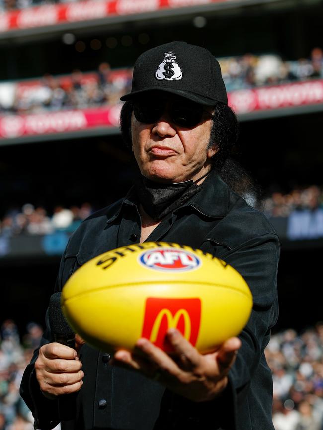 Carlton Blues fan Gene Simmons presents the match-day ball for the clash against the Collingwood Magpies at the MCG. Picture: Dylan Burns/AFL Photos via Getty Images