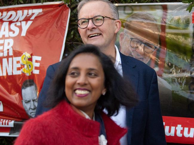 Opposition leader Anthony Albanese (back) and Labour candidate for Higgins Dr Michelle Ananda-Rajah arrive at a Polling station during election day in Carnegie, Melbourne, Australia on May 21, 2022. - Polls opened in Australia's federal election May 21, 2022 , with Prime Minister Scott Morrison fighting for another three-year term that would extend a decade of conservative rule. (Photo by Wendell Teodoro / AFP)