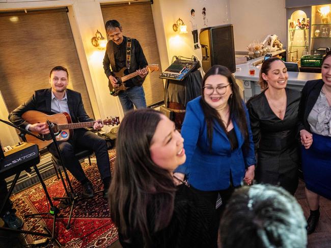 Chairman of Demokraatit, Jens-Frederik Nielsen (L) plays guitar during the election party at Demokraatit at cafe Killut in Nuuk, March 11, 2025. The centre-right opposition Democrats have won a surprise victory in legislative elections in Greenland, the Danish territory coveted by US President Donald Trump, more than tripling their support to 29.9 percent of votes, official results showed Wednesday March 12. (Photo by Mads Claus Rasmussen / Ritzau Scanpix / AFP) / Denmark OUT