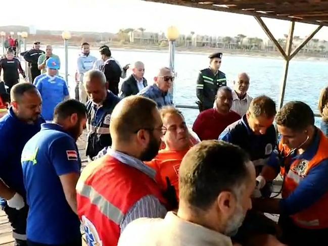 First-responders tending to a man on a stretcher in the Red Sea harbour town of Marsa Alam. Picture: EGYPTIAN SIS / AFP