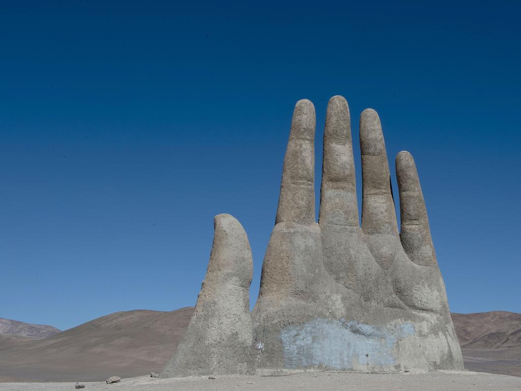 A picture of “La Mano del Desierto” (The Hand of the Desert), an 11 meter-tall monument by Chilean sculptor Mario Irrazabal produced in 1992, is seen in the outskirts of Antofagasta, Chile on June 14, 2015. Picture: AFP