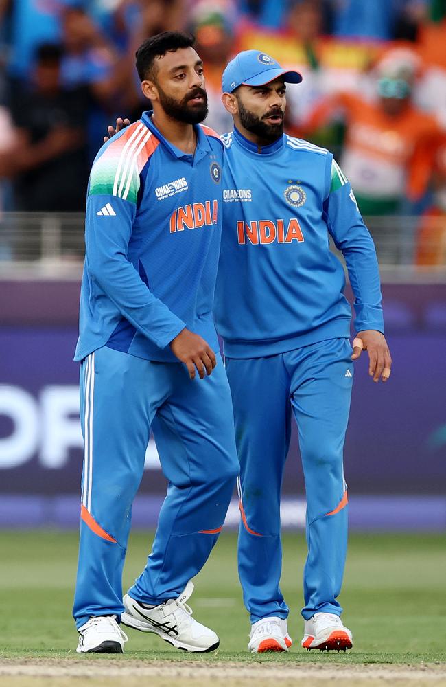 Varun Chakravarthy celebrates with teammate Virat Kohli after taking the wicket of Will Young. Picture: Getty Images