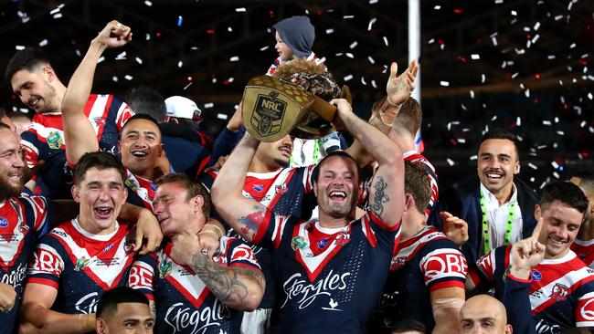 SYDNEY, AUSTRALIA - SEPTEMBER 30: Boyd Cordner of the Roosters celebrates with the Proven-SummonsÃŠTrophy and team mates after winning the 2018 NRL Grand Final match between the Melbourne Storm and the Sydney Roosters at ANZ Stadium on September 30, 2018 in Sydney, Australia. (Photo by Cameron Spencer/Getty Images)