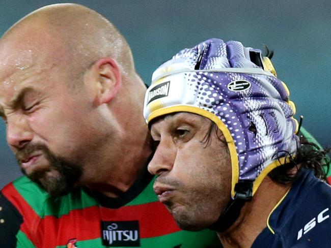 Cowboy's Johnathan Thurston hit by Rabbitoh's Glenn Stewart after he passed the ball during the round 6 NRL game between the South Sydney Rabbitohs and the North Queensland Cowboys at ANZ Stadium.Picture Gregg Porteous