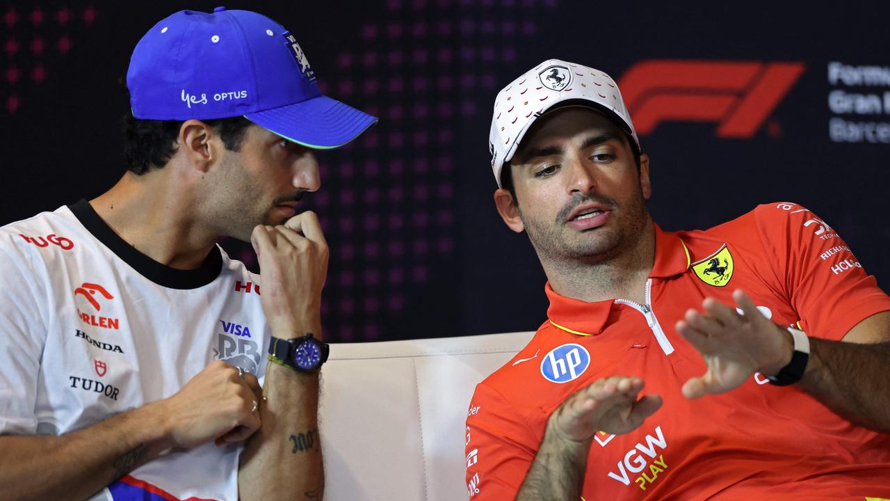 Ferrari's Spanish driver Carlos Sainz (R) speaks with RB's Australian driver Daniel Ricciardo during a press conference at the Circuit de Catalunya on June 20, 2024 in Montmelo, on the outskirts of Barcelona, ahead of the Spanish Formula One Grand Prix. (Photo by Thomas COEX / AFP)