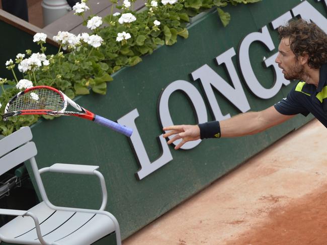 Gulbis tosses a broken racquet into the crowd at Roland Garros this week.