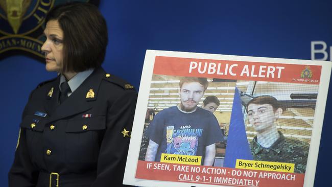 Security camera images recorded in Saskatchewan of Kam McLeod, 19, and Bryer Schmegelsky, 18, are displayed as Royal Canadian Mounted Police Sgt. Janelle Shoihet listens during a news conference in British Columbia.