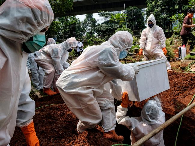 Government health workers bury a suspected victim of Covid-19, who died at home in Jakarta, Indonesia. Picture: Ed Wray/Getty Images