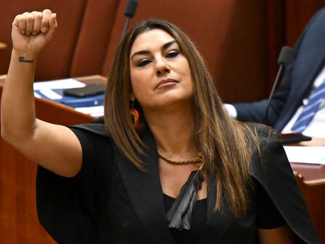 Australia Greens Senator for Victoria Lidia Thorpe raises her arm during her swearing-in ceremony in the Senate chamber at Parliament House in Canberra, Monday, August 1, 2022. (AAP Image/Lukas Coch) NO ARCHIVING