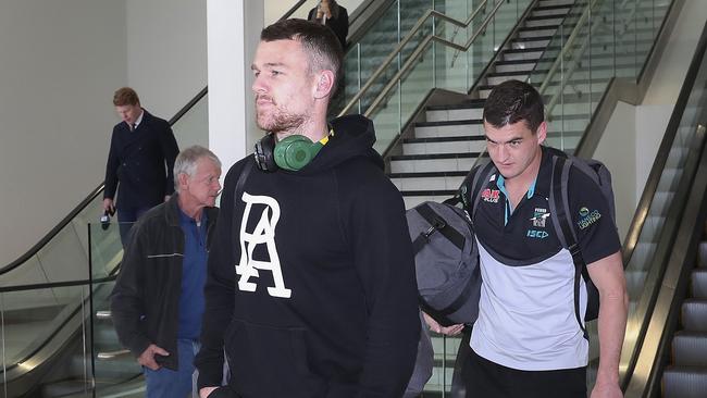 Robbie Gray and Tom Rockliff arrive back in Adelaide after the loss to Fremantle. Picture SARAH REED