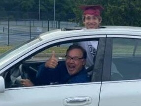 Nathan Vass (driving) and son Noah Vass get ready to take part in Noah's graduation parade through their hometown north of Manhattan. Picture: Sarah Blake