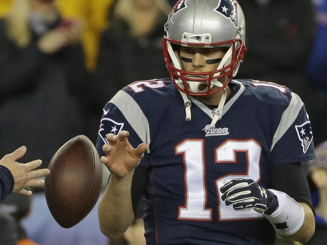 In this Sunday, Jan. 18, 2015, photo New England Patriots quarterback Tom Brady has a ball tossed to him during warmups before the NFL football AFC Championship game against the Indianapolis Colts in Foxborough, Mass. The NFL says its investigation into whether the New England Patriots used underinflated footballs in the AFC championship game is ongoing after a report Tuesday night. Jan. 20, 2015, claimed the league found 11 balls were not properly inflated. (AP Photo/Matt Slocum, File)