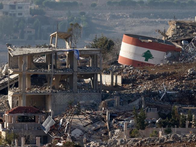 A Lebanese flag painted on a damaged building in the southern Lebanese village of Meiss El-Jabal last month. Picture: Jalaa Mare/AFP