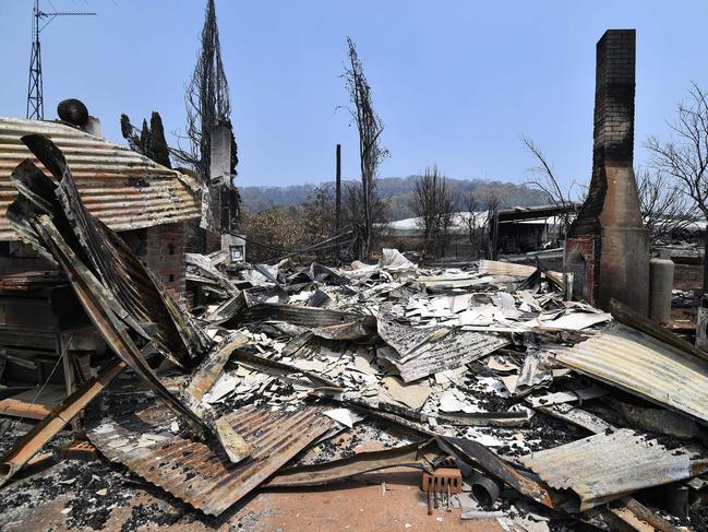 A burnt house is seen after bushfire in Batlow, in Australia's New South Wales state on January 8, 2020. - Australian officials issued fresh evacuation warnings on January 8, 2020 ahead of a forecast spike in the intensity of out-of-control bushfires that have devastated vast swathes of countryside and sent smoke clouds as far away as Brazil. (Photo by SAEED KHAN / AFP)