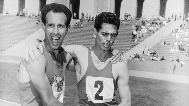 Runner John Landy congratulates South Africa’s Jim Bailey after he won a special one-mile race.