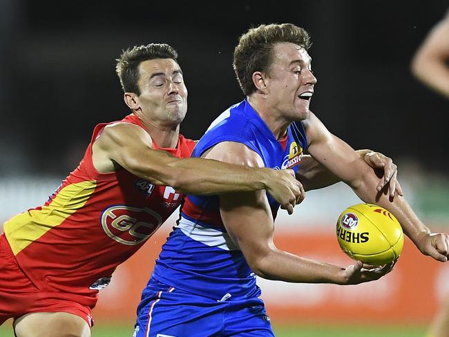 MACKAY, AUSTRALIA - MARCH 03: Jack Macrae of the Bulldogs is tackled by Lachie Weller of the Suns during the 2019 JLT Community Series AFL match between the Gold Coast Suns and the Western Bulldogs at Great Barrier Reef Arena on March 03, 2019 in Mackay, Australia. (Photo by Ian Hitchcock/Getty Images)