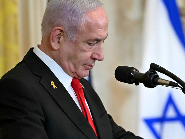 Israel's Prime Minister Benjamin Netanyahu attends a press conference with unseen US President Donald Trump in the East Room of the White House in Washington, DC, on February 4, 2025. Netanyahu met Trump at the White House Tuesday for crucial talks on the truce with Hamas, as the US president suggested permanently resettling Palestinians from war-battered Gaza. (Photo by ANDREW CABALLERO-REYNOLDS / AFP)