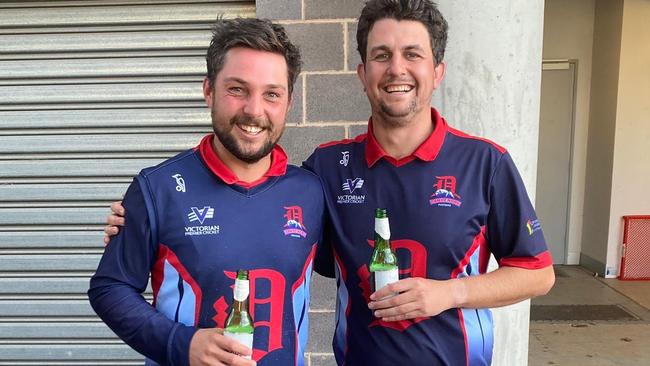 Jacques Augustin and Peter Cassidy enjoy a celebratory sip after Dandenong defeated Geelong. Pic: Akshat Buch World of Photography.