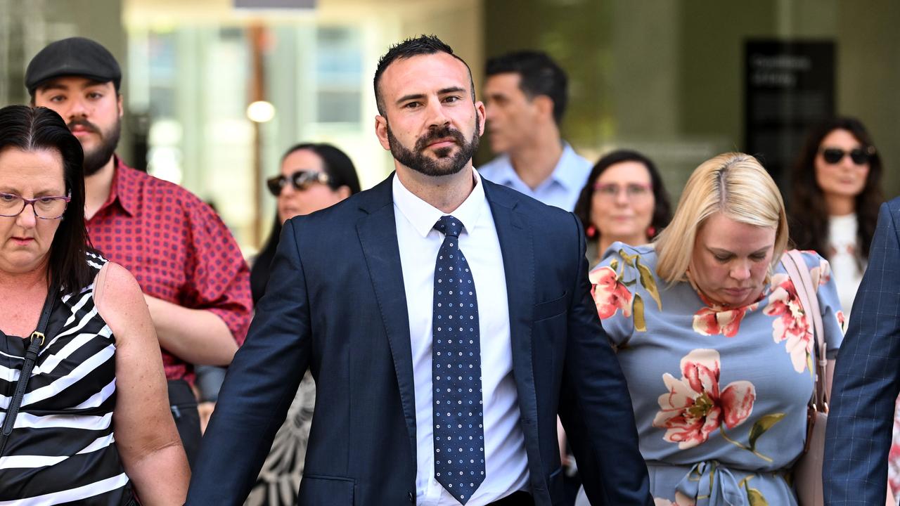 James Puglia (centre), the brother of Christopher Puglia, leaves the Supreme Court in Brisbane.