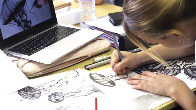 Marian student draws while studying from home