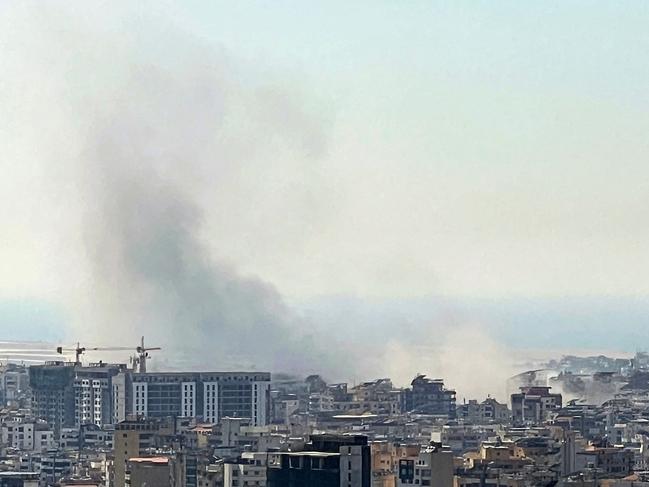 Smoke rises from the site of an Israeli airstrike that targeted a neighbourhood in Beirut's southern suburbs on October 8, 2024.  (Photo by Mohammad ABOU AL AINAIN / AFP)