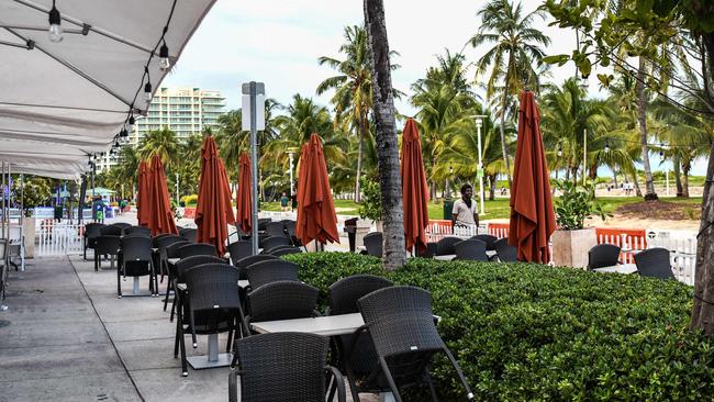 A man walks past a closed restaurant on Ocean Drive in Miami Beach, Florida. Picture: AFP)