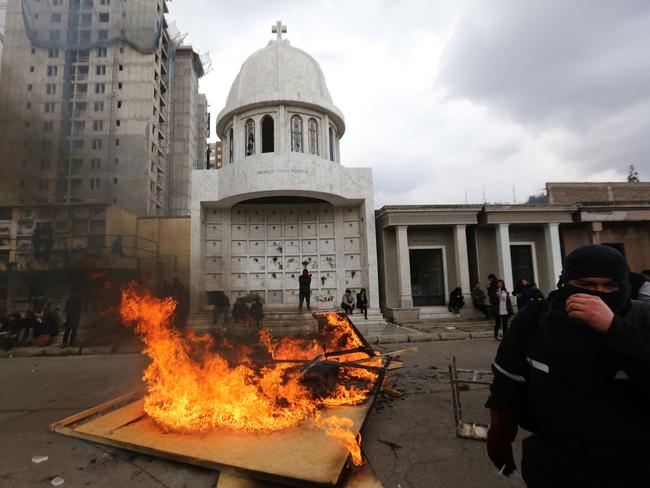 Demonstrators and riot police clash in Santiago during the commemoration of the 44th anniversary of the military coup led by Pinochet. Picture: AFP