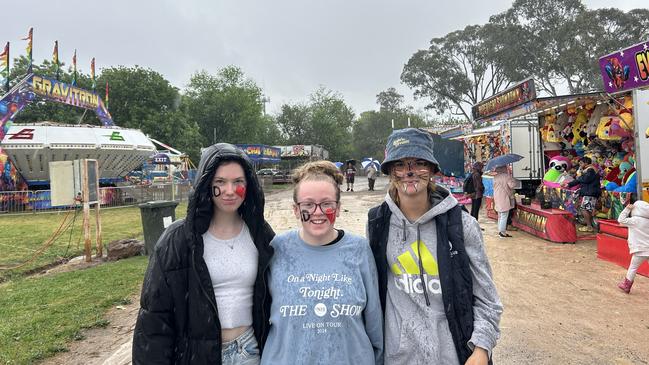 Bree Williams, Abbey Richards and Amanda Ward braved the rain on Friday at the Benalla Show.