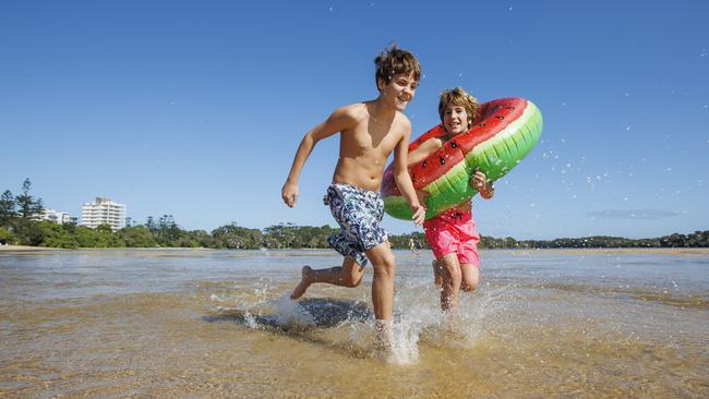 11 year old twins Rodrigo and Jorge Valz, from Alicante in Spain lap up the return of warm weather at Currimundi. Picture Lachie Millard