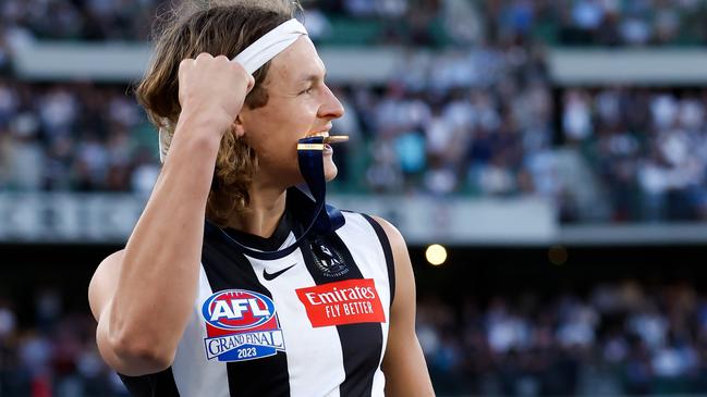 MELBOURNE, AUSTRALIA - SEPTEMBER 30: Jack Ginnivan of the Magpies celebrates after receiving his premiership medal during the 2023 AFL Grand Final match between the Collingwood Magpies and the Brisbane Lions at the Melbourne Cricket Ground on September 30, 2023 in Melbourne, Australia. (Photo by Dylan Burns/AFL Photos via Getty Images)