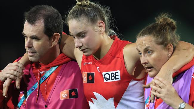 Ham is helped off the ground at North Sydney Oval on Saturday night.