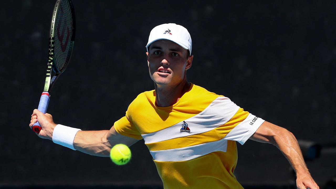 Australia's Christopher O'Connell hits a return against Argentina's Diego Schwartzman.