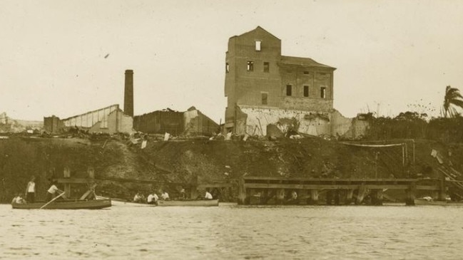 Millaquin Distillery Fire Aftermath, 1936. A sombre scene as onlookers row their boats up the river to view the fire damage. Source: John Oxley Library, State Library of Queensland