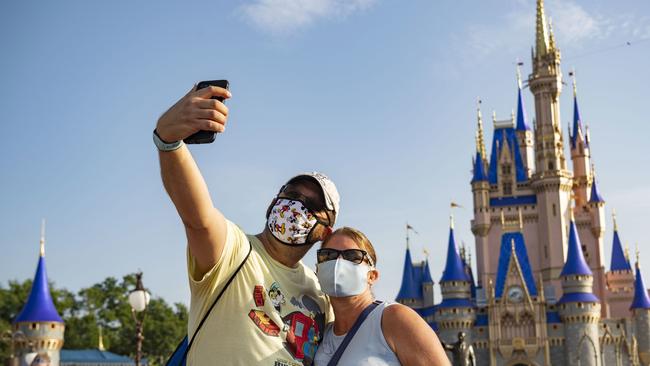 Guests stop to take a selfie at Magic Kingdom Park at Walt Disney World Resort on July 11, 2020 in Lake Buena Vista, Florida, the first day of the theme park’s phased reopening. Picture: Getty Images