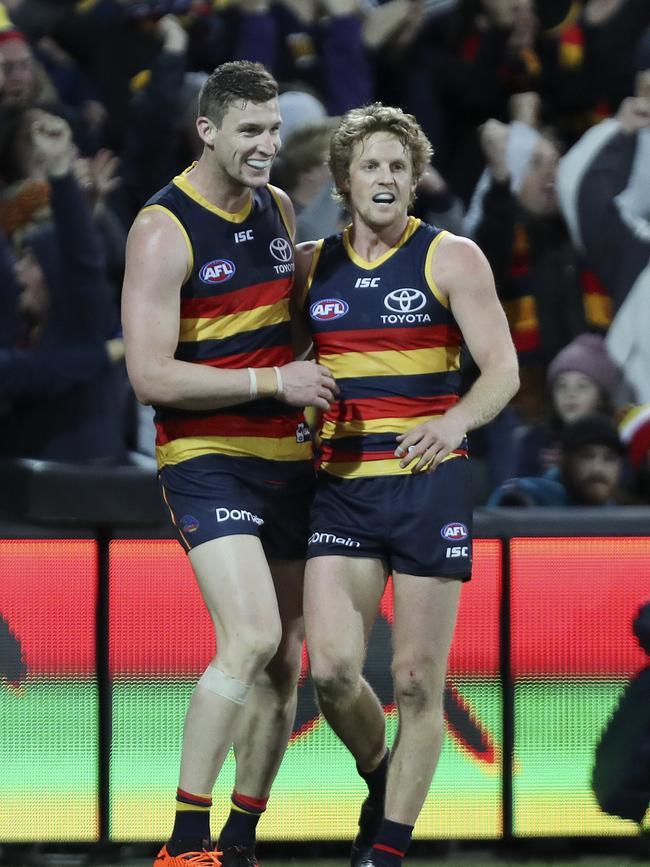 Josh Jenkins, regardless of the final controversy, had a huge game for the Crows and celebrates with Rory Sloane after the win. Picture SARAH REED