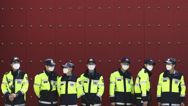 Police officers stand guard in front of the Chinese embassy in Seoul, South Korea, on Wednesday. Picture: AP