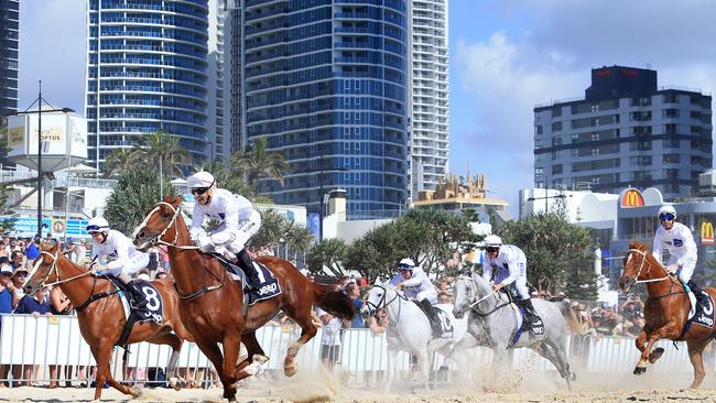 The Magic Millions Barrier Draw which now famously includes horses ripping down Surfers Paradise Beach, an amazing spectacle which draws big crowds. This is last January’s event. Picture: Tim Marsden