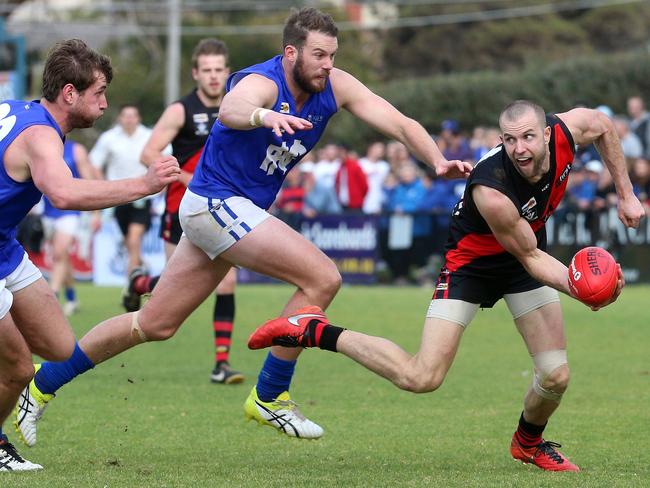 Frankston’s Beau Muston handballs under pressure. Picture: Mark Dadswell