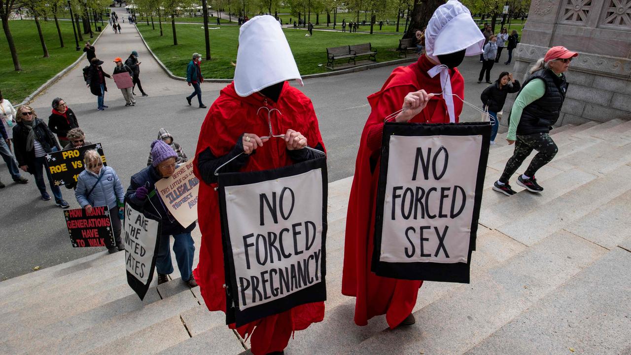 Protesters who are part of a group called the Boston Red Cloaks point out the similarity between the abortion bans and the restricted life of women in the novel and TV series Handmaid’s Tale in Boston in May. Picture: Joseph Prezioso/AFP