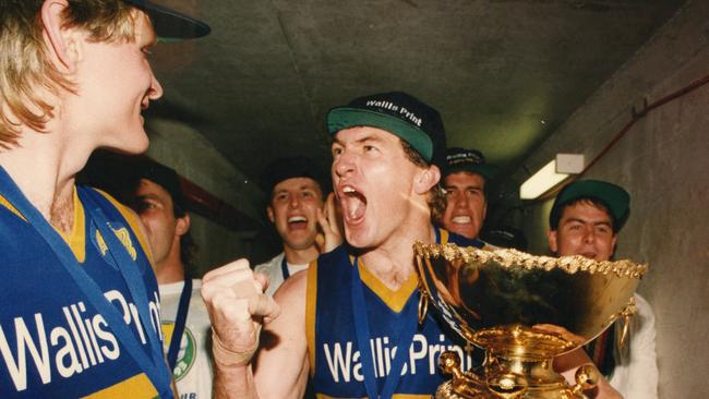 PERFECT DAY ... Eagles captain Peter Schwarz celebrates with Andrew Taylor as he holds the Thomas Seymour Hill trophy after winning the 1993 SANFL grand final.